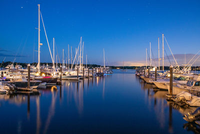 Sailboats moored in harbor