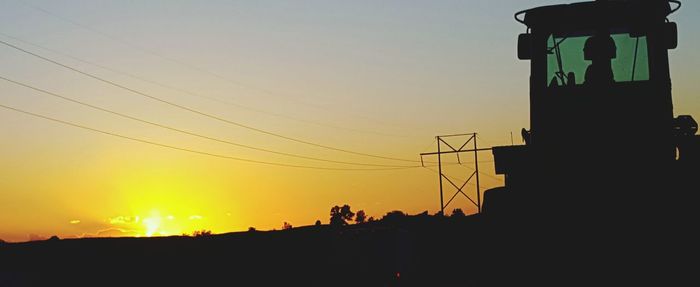 Silhouette of power lines at sunset