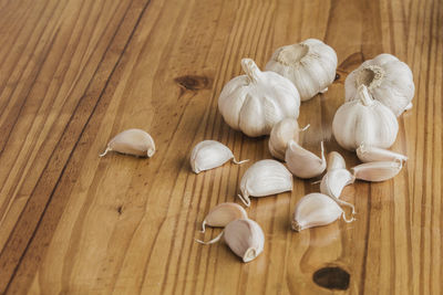 Garlic is a culinary and medicinal plant on a wooden background