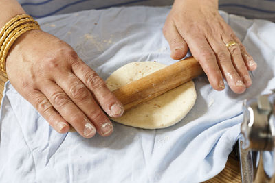 Cropped image of woman preparing dough at home