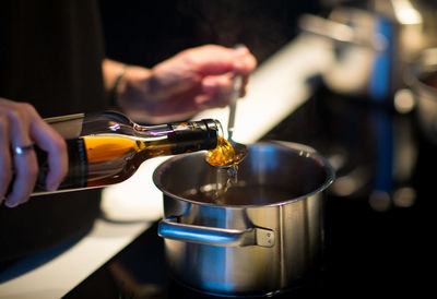 Midsection of person preparing food in kitchen