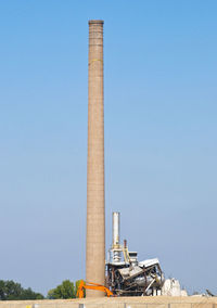 Old factory against clear blue sky