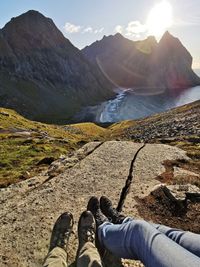 Low section of man in mountains against sky