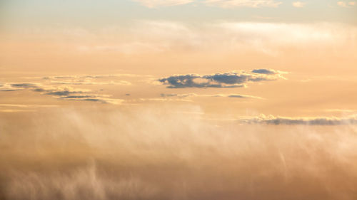 Scenic view of sand dunes against sky at sunset