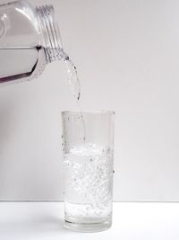 Close-up of drink in glass against white background