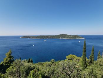 Scenic view of sea against clear blue sky