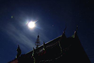 Low angle view of illuminated building against sky at night