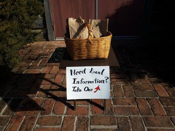 High angle view of text on wicker basket on footpath