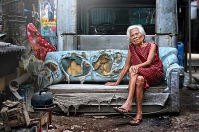 Portrait of a smiling young woman sitting on seat