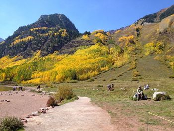 Group of people on land by mountain