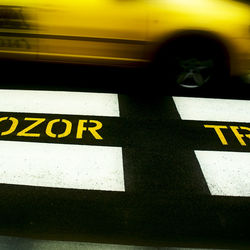 Yellow car on road in city