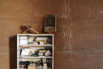 Old bottles on shelf against wall