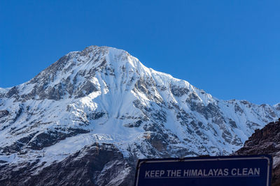 Snow covered mountains against clear blue sky