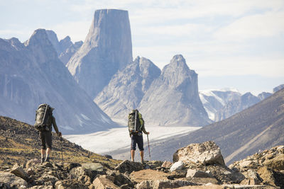Rear view of backpackers approaching mount asgard, akshayak pass.