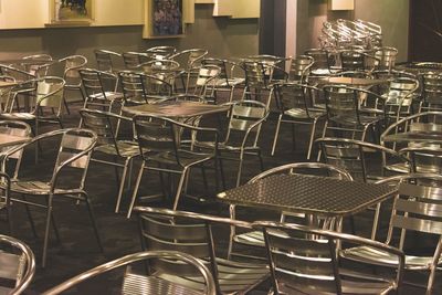 Empty chairs and tables in restaurant