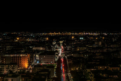 High angle view of city lit up at night