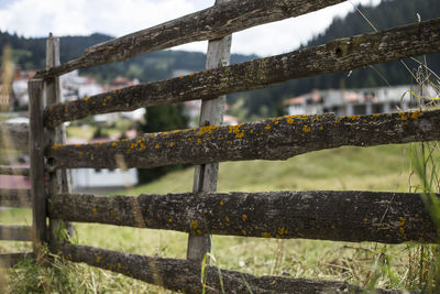 Close-up of old wooden fence on field