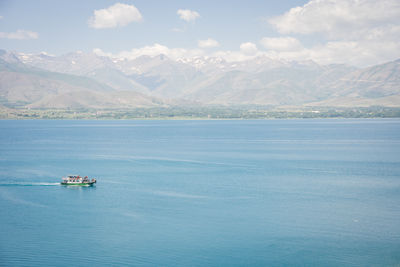 Scenic view of sea and mountains against sky