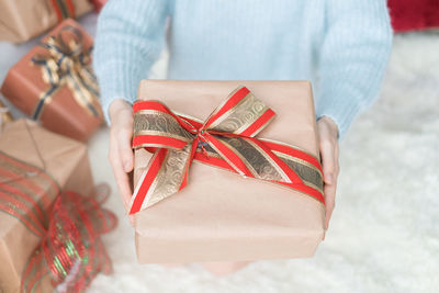 Midsection of woman holding gift