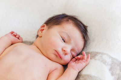 Cute baby boy lying on bed