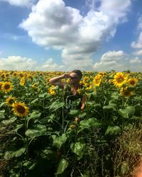 Scenic view of sunflower field against cloudy sky