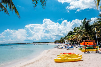 Boats at beach against sky