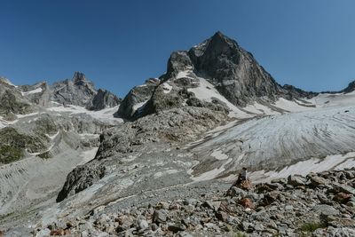 Scenic view of snowcapped mountains against clear blue sky