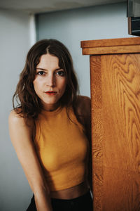 Portrait of beautiful young woman standing at home