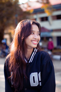 Portrait of young woman standing outdoors