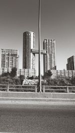 Street by buildings against sky in city