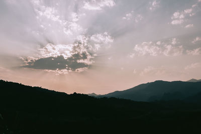 Scenic view of silhouette mountains against sky at sunset