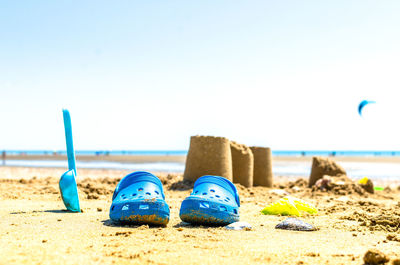 Surface level of beach against blue sky