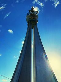 Low angle view of statue against blue sky