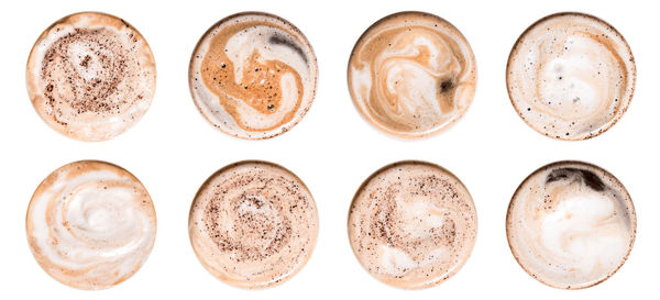 Directly above shot of coffee cups against white background