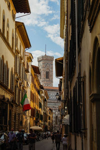 City street amidst buildings against sky