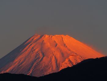 Scenic view of mountain against sky at sunset