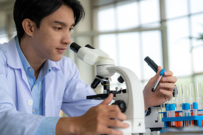 Side view of young man working at clinic