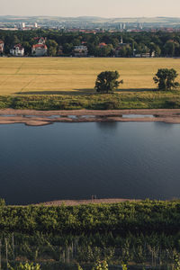 High angle view of field by lake