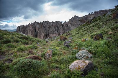 Rock formations on landscape against sky