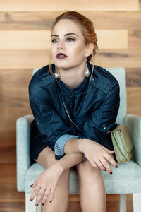 Portrait of woman sitting on sofa