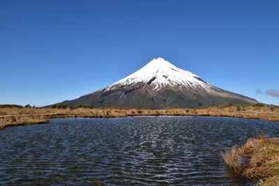 Scenic view of snowcapped mountains against clear blue sky