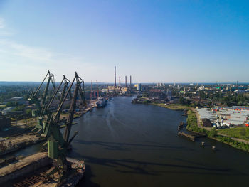 Scenic view of sea and buildings against clear sky