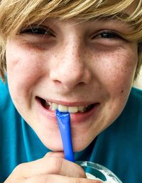 Portrait of cheerful boy drinking from straw