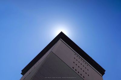 Low angle view of modern building against clear blue sky