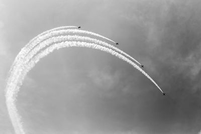 Low angle view of airplane flying against sky