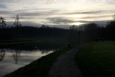 Scenic view of lake against cloudy sky