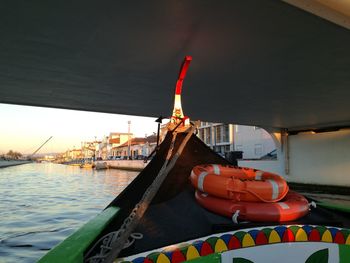 Boat by river against sky