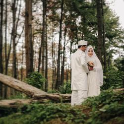 Couple standing in forest