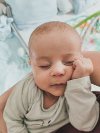 Portrait of cute baby boy on bed