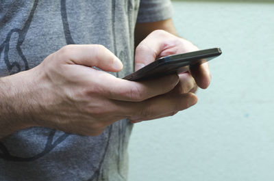 Close-up of man using mobile phone